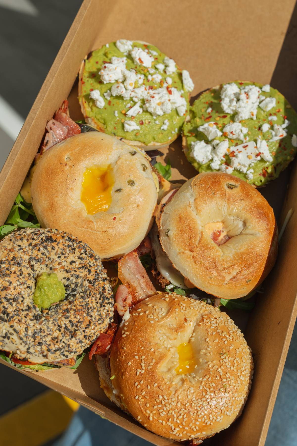 Dirty Deli filled bagels and open avocado bagels, served through Just Steak It